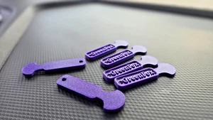 Four purple trolley coin keyrings