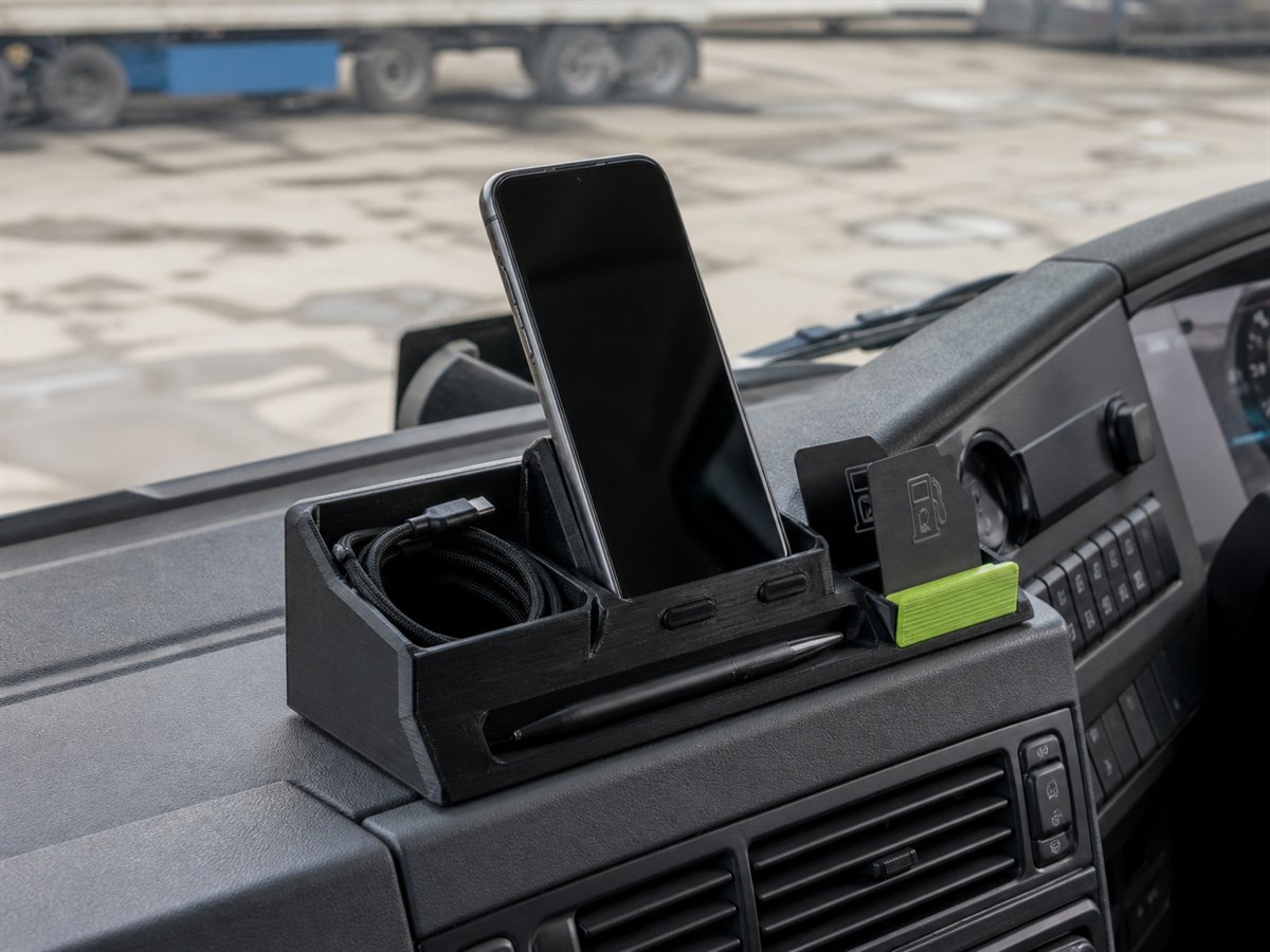 3D-printed DAF cab dock holding a phone, charging lead, pen and cards